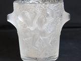 a glass vase with a design on it on a black surface