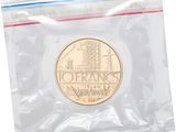 a close up of a coin in a plastic bag on a white background