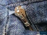 a close up of a zipper on a pair of jeans