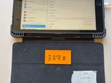 a tablet computer sitting on top of a desk with a notepad