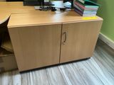 an image of a desk with a computer and a file cabinet