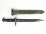 two knives are laying side by side on a white surface