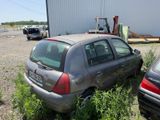two cars that are parked next to each other in the grass