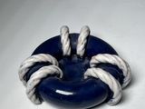 a blue and white ring with two hands on it