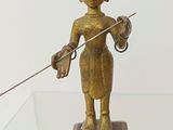 a statue of a woman holding a sword on a glass table