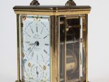 a small clock that is sitting on top of a table