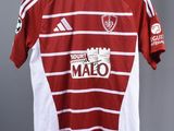 a red and white soccer shirt hanging on a hanger