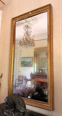 a large mirror hanging on the wall in a room