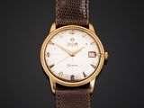 a gold plated wrist watch with brown leather strap