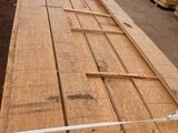 several pieces of wood are stacked on top of each other in a warehouse