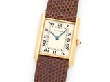 a lady ' s cartier watch with a brown leather strap