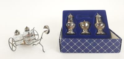 a miniature carriage with silverware in it and a blue box on the table