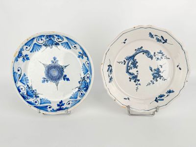 two blue and white plates with flowers and birds on them