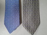 two ties that are sitting side by side on a table