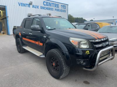 a black truck with orange stripes parked in front of a building