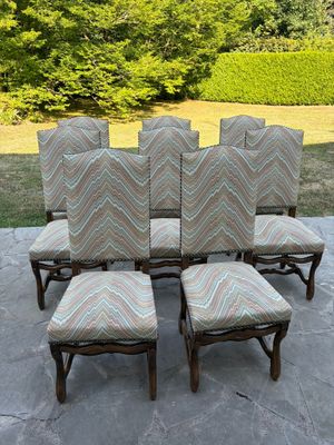 a set of six chairs and a table on a patio