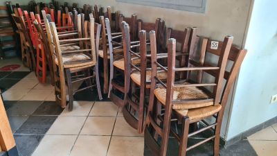 many wooden chairs lined up in a row in a room