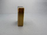 a gold lighter that is sitting on a table