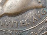 a close up of a bronze coin with a bird on it