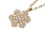 a diamond snowflake pendant on a gold chain