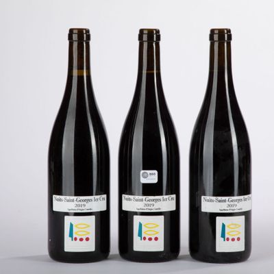three bottles of wine sitting next to each other on a table