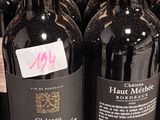 several bottles of wine are lined up on a shelf