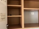 a small bathroom with a toilet and cabinets in it