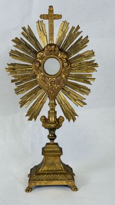 an image of a golden cross with a mirror on top of it
