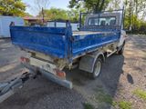 a blue truck that is parked in the dirt