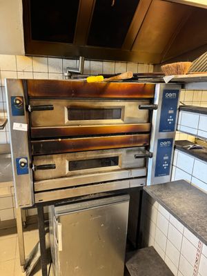 an oven that is sitting in the middle of a kitchen