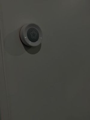 a digital thermosta on the wall of a bathroom