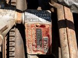 a close up of a rusted engine with a sign on it