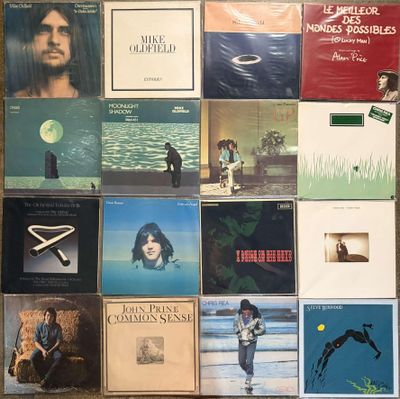 many different album covers on the wall of a room