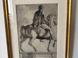 painting of a man riding a horse in a gold frame on a wall
