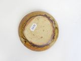 a close up of a vase with a tag on it