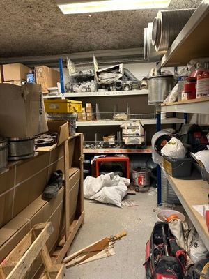 a room with a lot of clutter and tools on the shelves