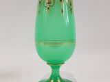 two green vases sitting next to each other on a table