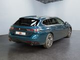 the rear end of a blue car parked in a garage