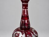 an image of a red and white vase on a gray surface