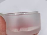 a person holding a clear plastic container in their hand