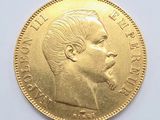 the gold coin has a profile of a man ' s face on it