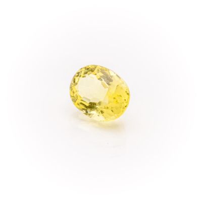 a yellow sapphire stone on a white background