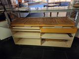 a glass display case with a wooden shelf underneath it