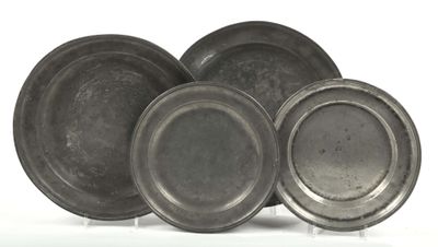 three silver plates are stacked on top of each other on a white surface