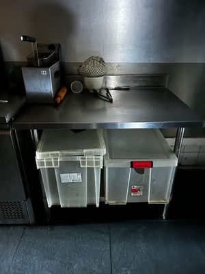 a metal counter with two bins on top of it