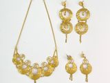 three pieces of gold jewelry including a necklace, earrings and a ring