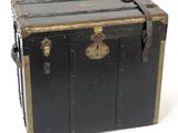 a black trunk with gold trim and a lock on it