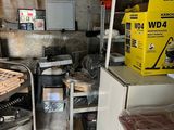 an image of a kitchen with a refrigerator and a lot of clutter