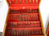 many forks and spoons in a red box