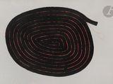 a black and red fire hose on a white surface